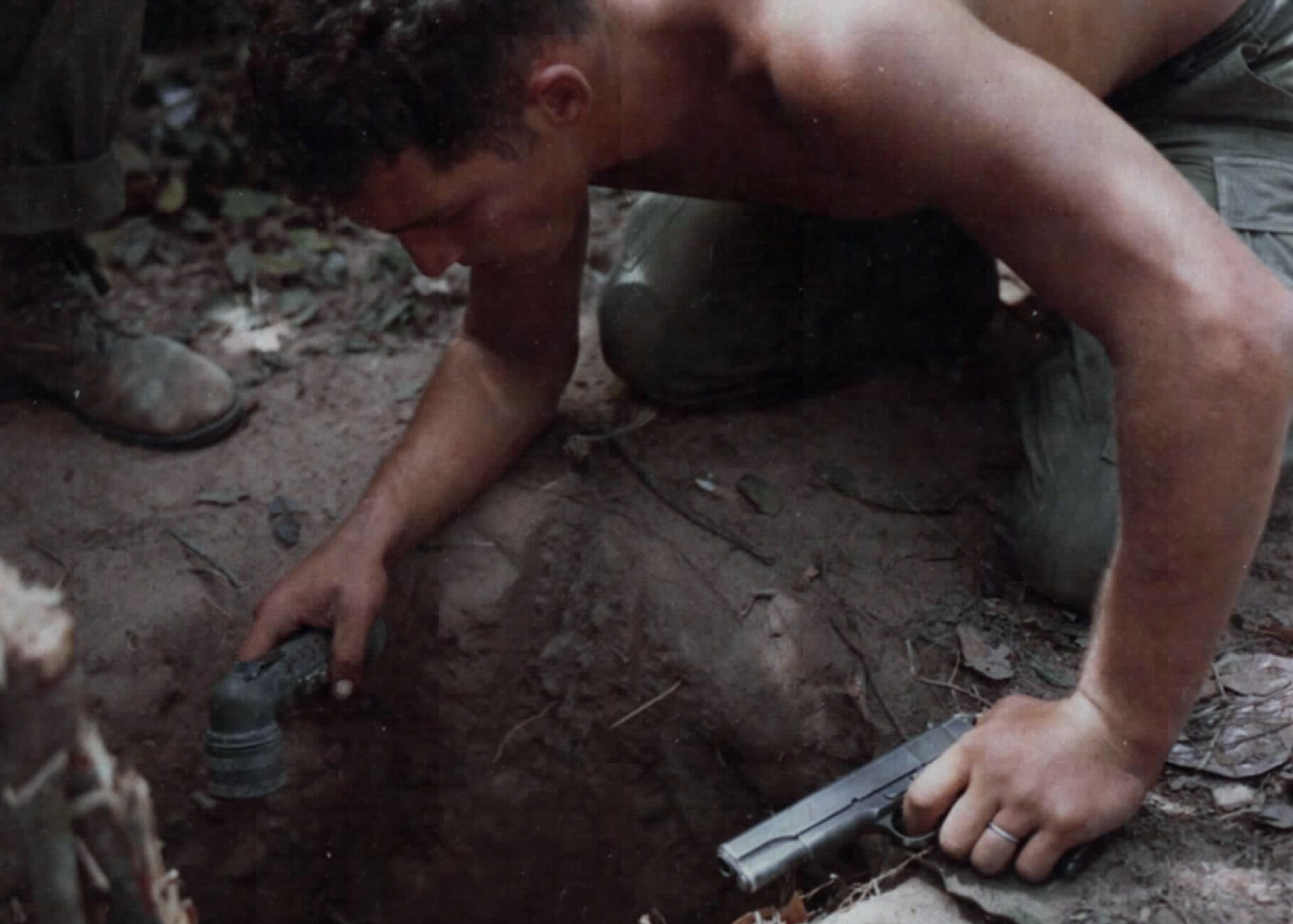 A US sergeant crawling through a tunnel during Operation Cedar Falls