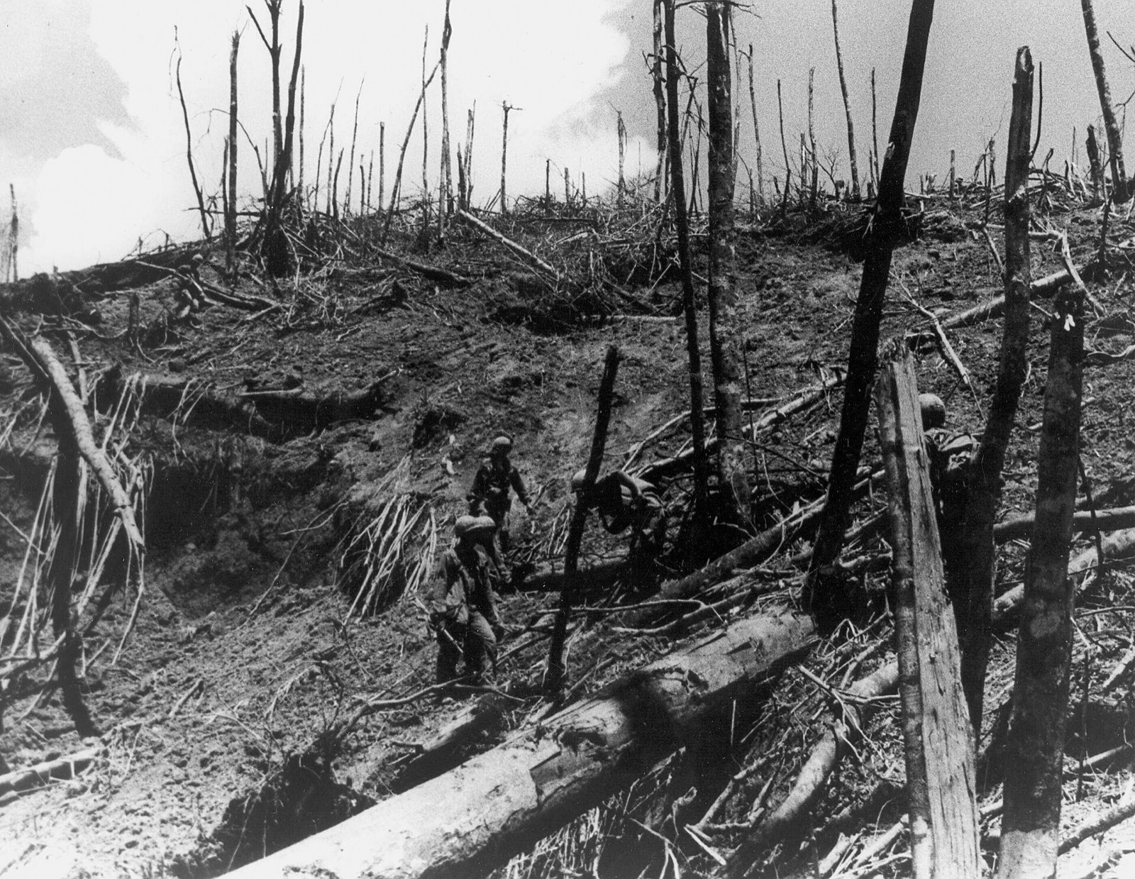 Troopers inspecting the shell-torn ground around Dong Ap Bia in May 1969.